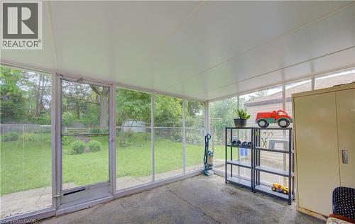 Screened-in patio with concrete flooring and a white paneled ceiling - 619 Forest Hill Drive, Kitchener, ON 