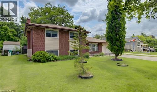 Split-level residence featuring a brick and siding exterior, brown shingle roof, and multiple windows - 619 Forest Hill Drive, Kitchener, ON 