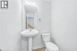 Pedestal sink with chrome faucet, mirror, and three-bulb vanity light fixture - 