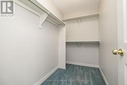 Walk-in closet in primary bedroom - 