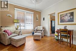 2nd Flr Living space featuring hardwood flooring, a ceiling fan, and a double window with blinds - 