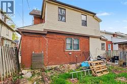 Exterior rear elevation featuring brick and horizontal siding - 