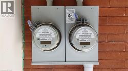 Dual utility meters mounted on a brick exterior wall - 