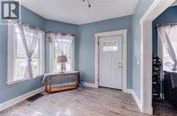 Entryway featuring wood-finish flooring and light blue walls - 