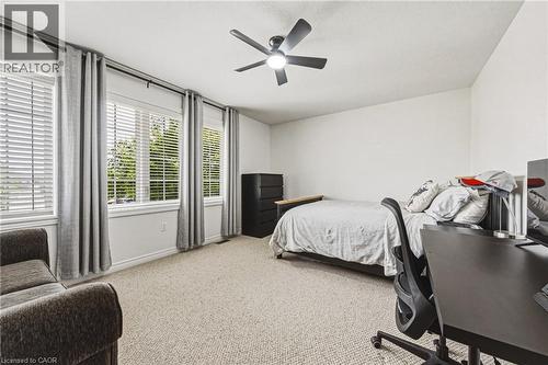 Spacious room featuring light-toned carpeting, white walls, and a ceiling fan with integrated lighting - 20 Degrow Crescent, Binbrook, ON 