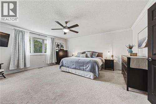 Spacious room featuring light-colored carpeting, an overhead ceiling fan with lighting, and white walls - 20 Degrow Crescent, Binbrook, ON 