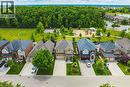 Neighborhood featuring single-family residences, a large green space, a playground, and mature trees - 20 Degrow Crescent, Binbrook, ON 