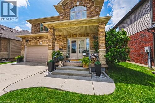 Brick and stone facade with a covered porch entry - 20 Degrow Crescent, Binbrook, ON 