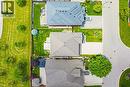 Aerial perspective of a residential street featuring three homes with varied rooflines and driveways - 20 Degrow Crescent, Binbrook, ON 