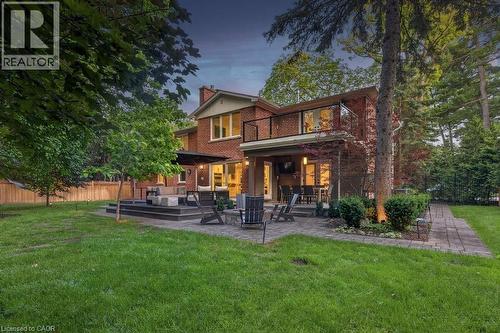 Expansive backyard featuring a manicured lawn, multi-level composite decking, and a stone paver patio - 1638 Ruscombe Close, Mississauga, ON 