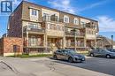 Multi-level townhouse complex featuring a Mansard roof, brick veneer, and light-colored siding - 236 Rachel Crescent Unit# E, Kitchener, ON 