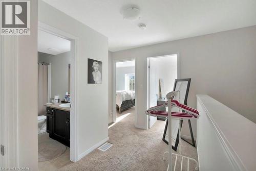 Upper-level hallway featuring light-toned carpeting and neutral wall paint - 236 Rachel Crescent Unit# E, Kitchener, ON 