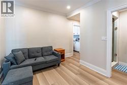 Light-toned wood-finish flooring complements neutral wall tones and white trim throughout this space - 
