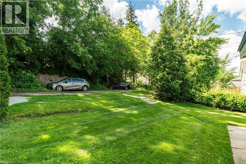 Expansive lawn area with a gentle slope and mature trees - 66 Queen Street W, Cambridge, ON 