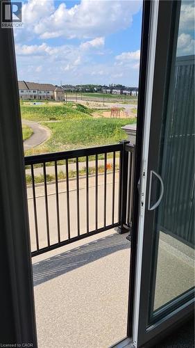 Balcony featuring dark metal railings and a speckled textured surface - 42 Wheat Lane Unit# 42, Kitchener, ON 