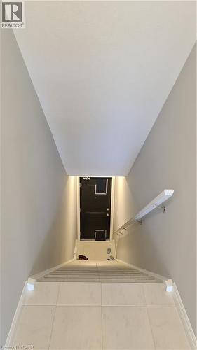 Stairwell featuring light gray walls, a white ceiling, and light-toned tile flooring - 42 Wheat Lane Unit# 42, Kitchener, ON 