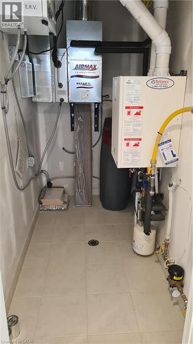 Utility room featuring light-toned square floor tiles with a central floor drain - 42 Wheat Lane Unit# 42, Kitchener, ON 