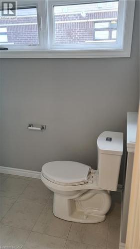 Bathroom featuring a white toilet, light gray painted walls, and light-toned floor tiling - 42 Wheat Lane Unit# 42, Kitchener, ON 