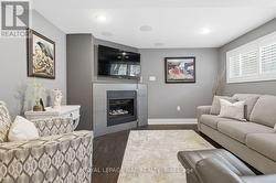 Family room shows gas fireplace & TV - 