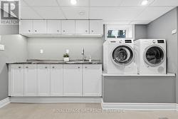 Laundry rm shows pedal rise for washer & dryer - 