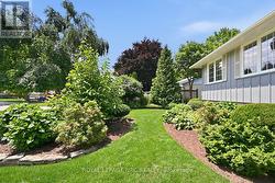 Front along to side of lush gardens - 