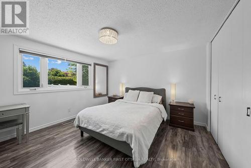 Primary bedroom w bright window facing backyard. - 12 Bradgate Drive, Ottawa, ON 