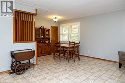 Dining area featuring light-toned tile flooring and pale blue walls - 