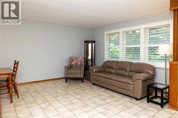 Spacious interior room featuring light-toned flooring, expansive windows with horizontal blinds, and a neutral wall color - 