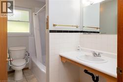 Bathroom featuring a single vanity with an integrated sink, chrome faucet, and mirrored medicine cabinet - 