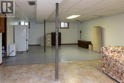 Spacious lower level featuring a drop ceiling, recessed lighting, and a combination of resilient flooring and tile - 