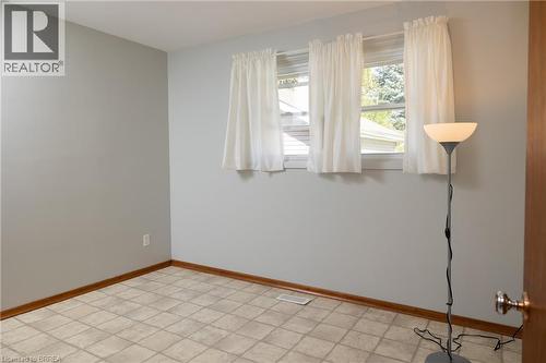 Lower level offering an expansive open area, drop ceiling, and multiple lighting fixtures - 156 Mutual Street N, Ingersoll, ON 
