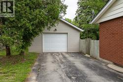 Detached garage with horizontal vinyl siding and a paneled overhead door - 