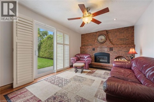 Brick fireplace with an arched wood storage area - 7 Thomson Road, Simcoe, ON 