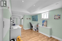 Interior room featuring wood-finish flooring, recessed lighting, and a window with white trim - 