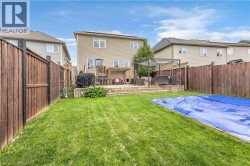 Expansive backyard featuring a multi-level wood-finish deck, a pergola, and a covered pool area - 
