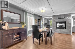 Dining area featuring wood-finish flooring and a coffered ceiling - 