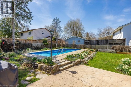 Backyard featuring an in-ground swimming pool with concrete surround and metal handrails - 277 Blackacres Boulevard, London, ON 