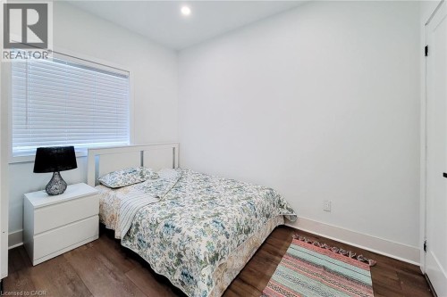 Bright room featuring wood-finish flooring and a white window frame with horizontal blinds - 78 Hillyard Street, Hamilton, ON 