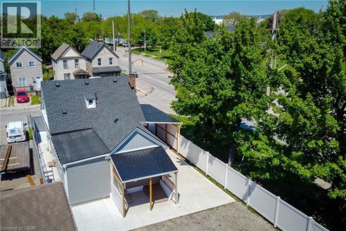 Aerial perspective showcasing a property with a gray shingle roof, light gray siding, and a white privacy fence - 78 Hillyard Street, Hamilton, ON 