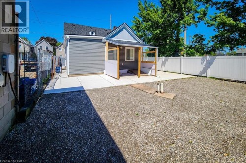 Rear exterior featuring gray siding and white trim - 78 Hillyard Street, Hamilton, ON 