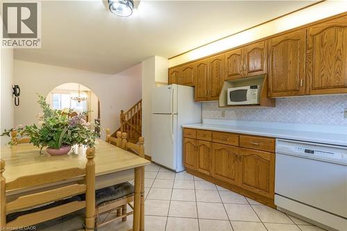Functional eat-in kitchen w/ natural wood cabinets - 102 Markson Crescent, Hamilton, ON 