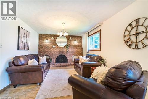 Family room with beautiful wood fireplace - 102 Markson Crescent, Hamilton, ON 