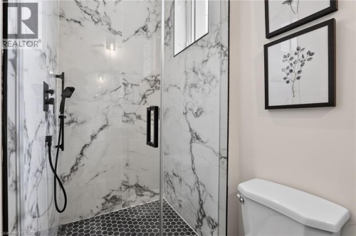 Walk-in shower with clear glass enclosure and black hardware - 118 Cathcart Street, Hamilton, ON 
