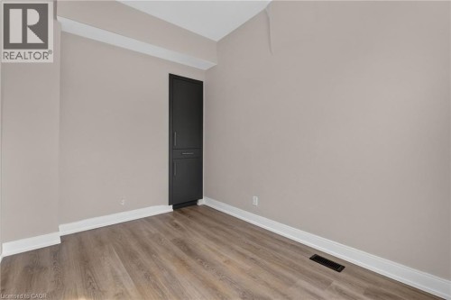 Neutral wall finish with an integrated matte black storage cabinet - 118 Cathcart Street, Hamilton, ON 