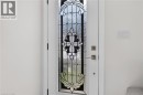 Entry door with leaded glass panel featuring intricate decorative patterns - 118 Cathcart Street, Hamilton, ON 