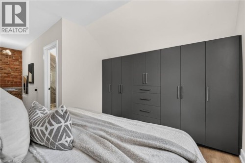 Floor-to-ceiling built-in cabinetry featuring sleek dark panels and brushed nickel hardware - 118 Cathcart Street, Hamilton, ON 