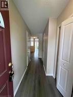 Entryway featuring a dark wood-finish floor and neutral wall tones - 