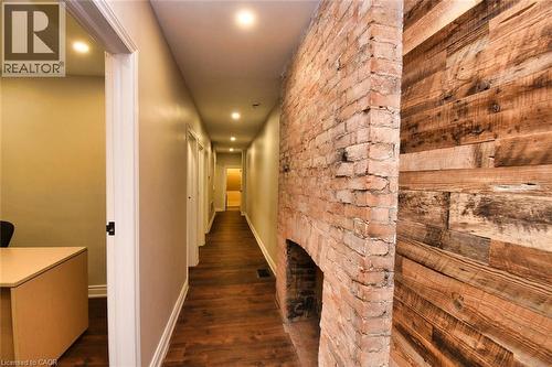 Hallway featuring wood-finish flooring, recessed lighting, and neutral wall paint - 242 James Street S, Hamilton, ON 