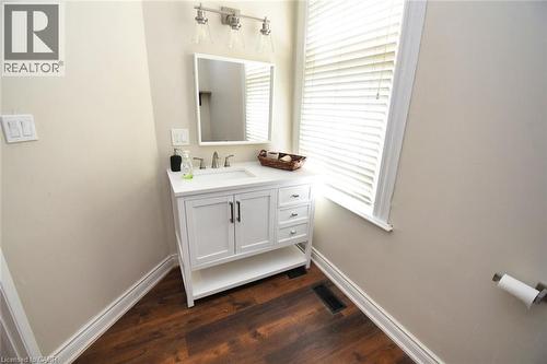 White vanity with brushed nickel hardware and a single-basin sink - 242 James Street S, Hamilton, ON 