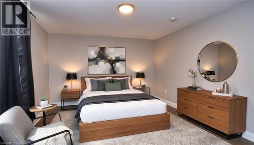 Spacious room featuring neutral wall tones, recessed lighting, and wood-finish flooring - 242 James Street S, Hamilton, ON 